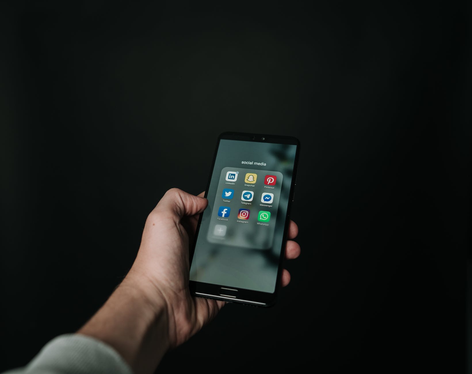 A pciture of a phone with social media apps installed on it. Photo by Magnus Mueller on Pexels.com